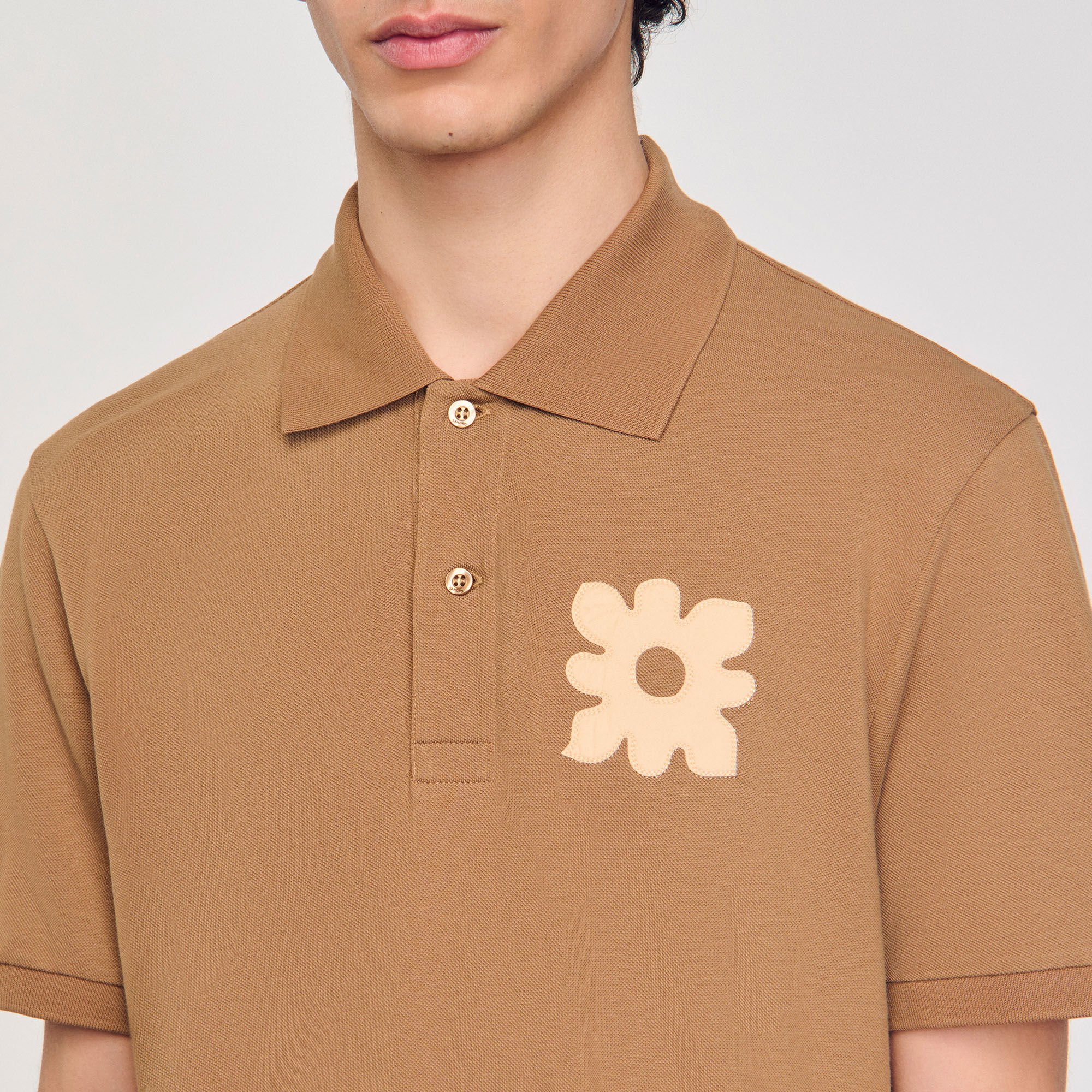 Polo shirt with flower patch