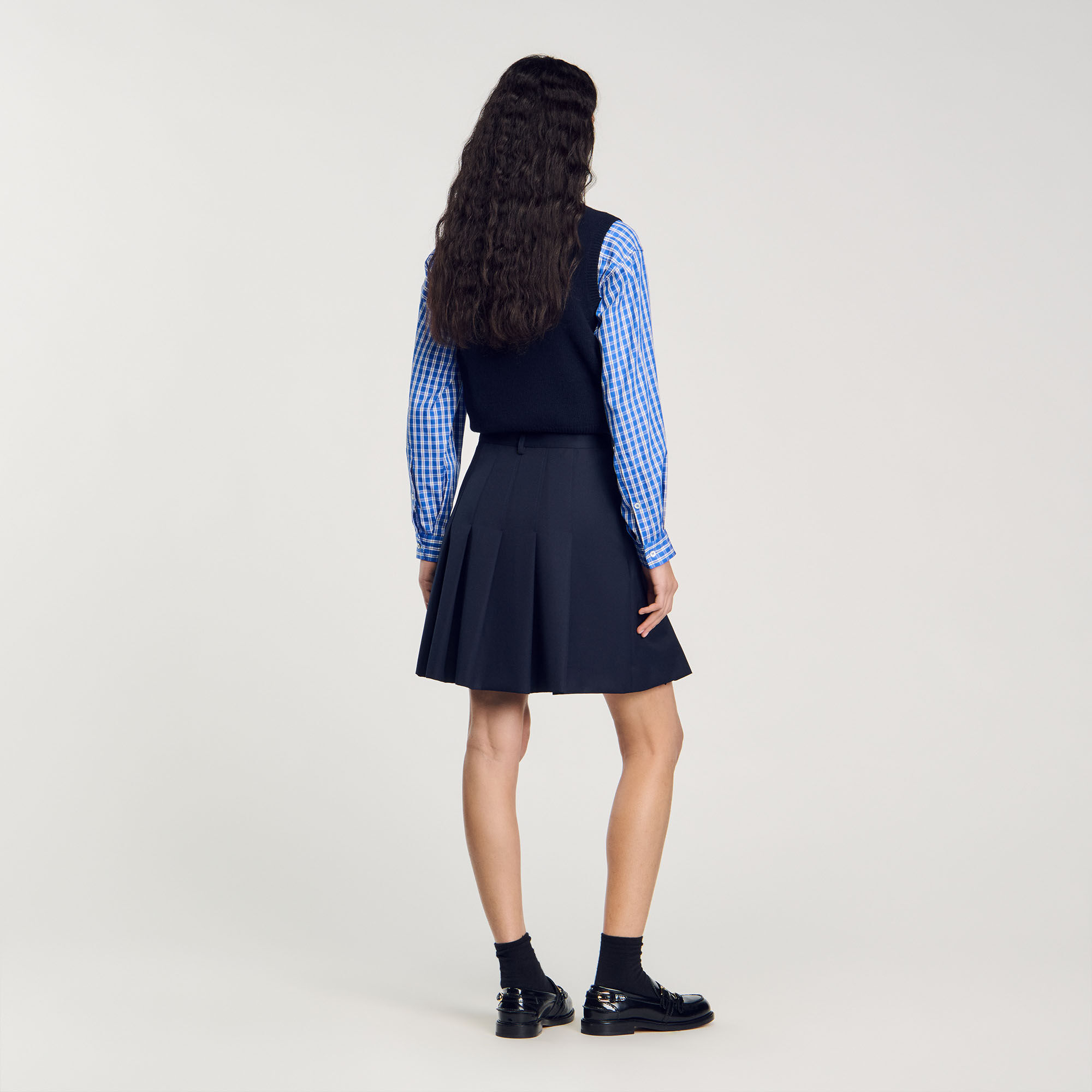Short asymmetrical pleated skirt