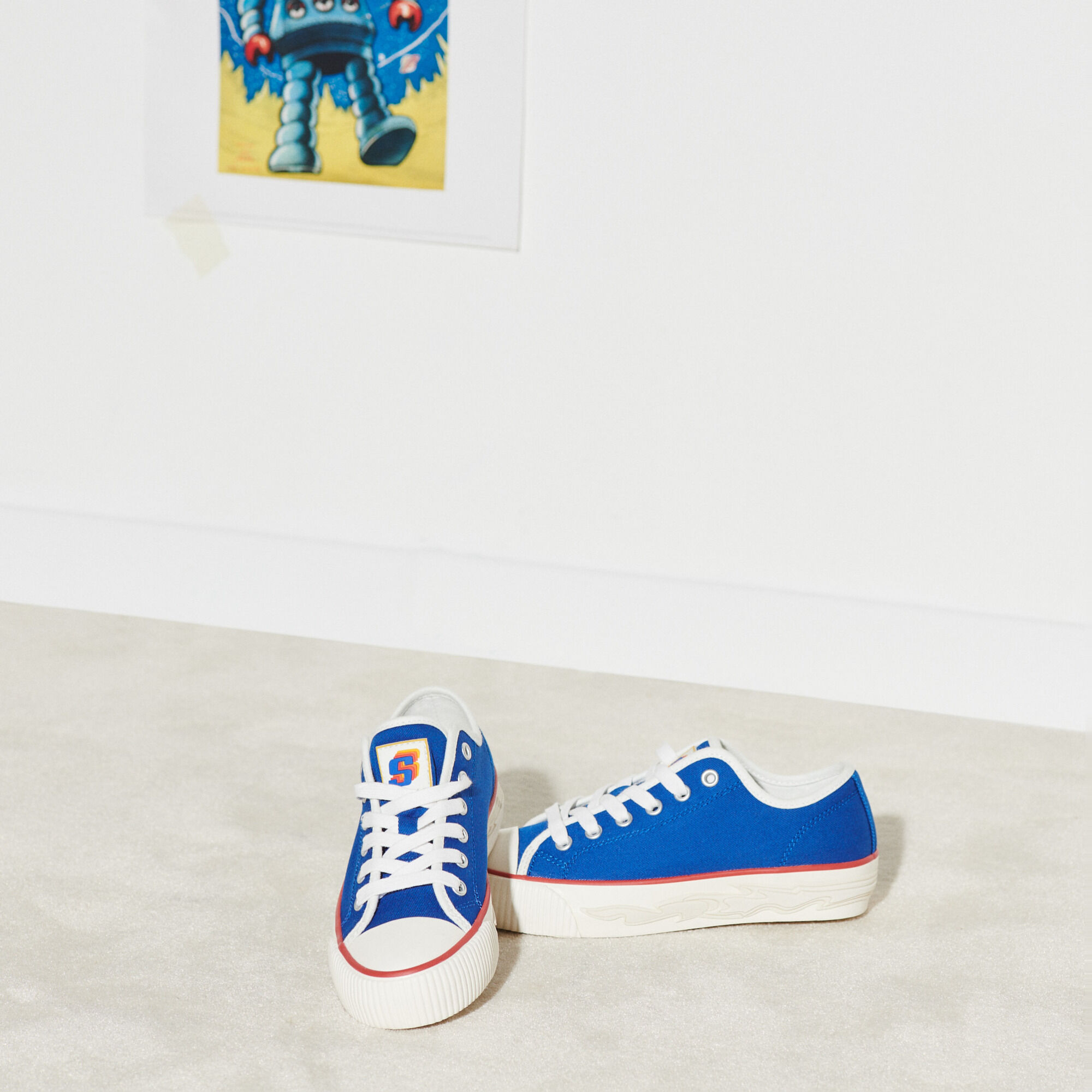 canvas sneakers with a blue logo