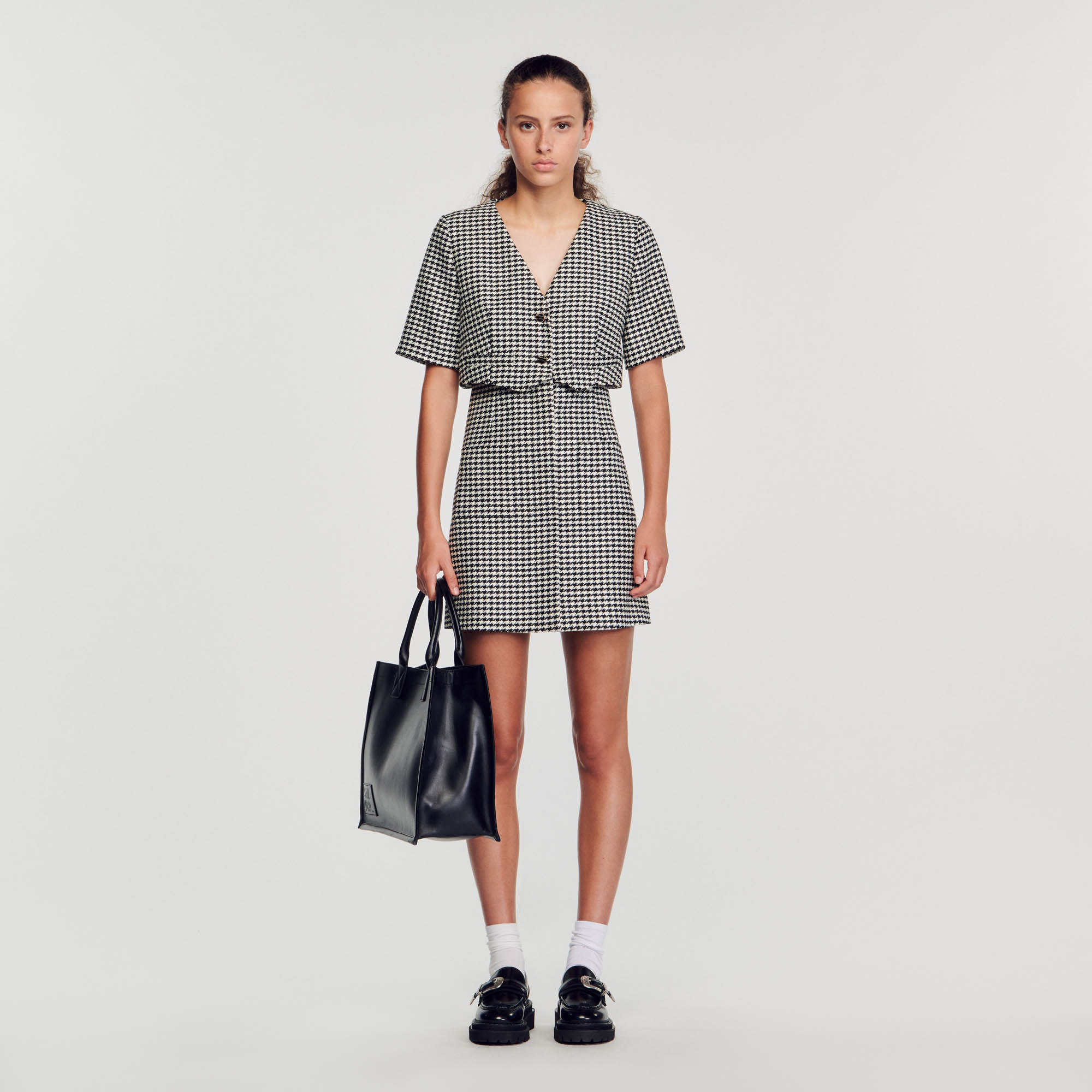 Sandro acrylic Short houndstooth tweed 2-in-1 dress featuring a layered top with a crossover V-shaped neckline and buttons, short sleeves, and a straight-cut skirt