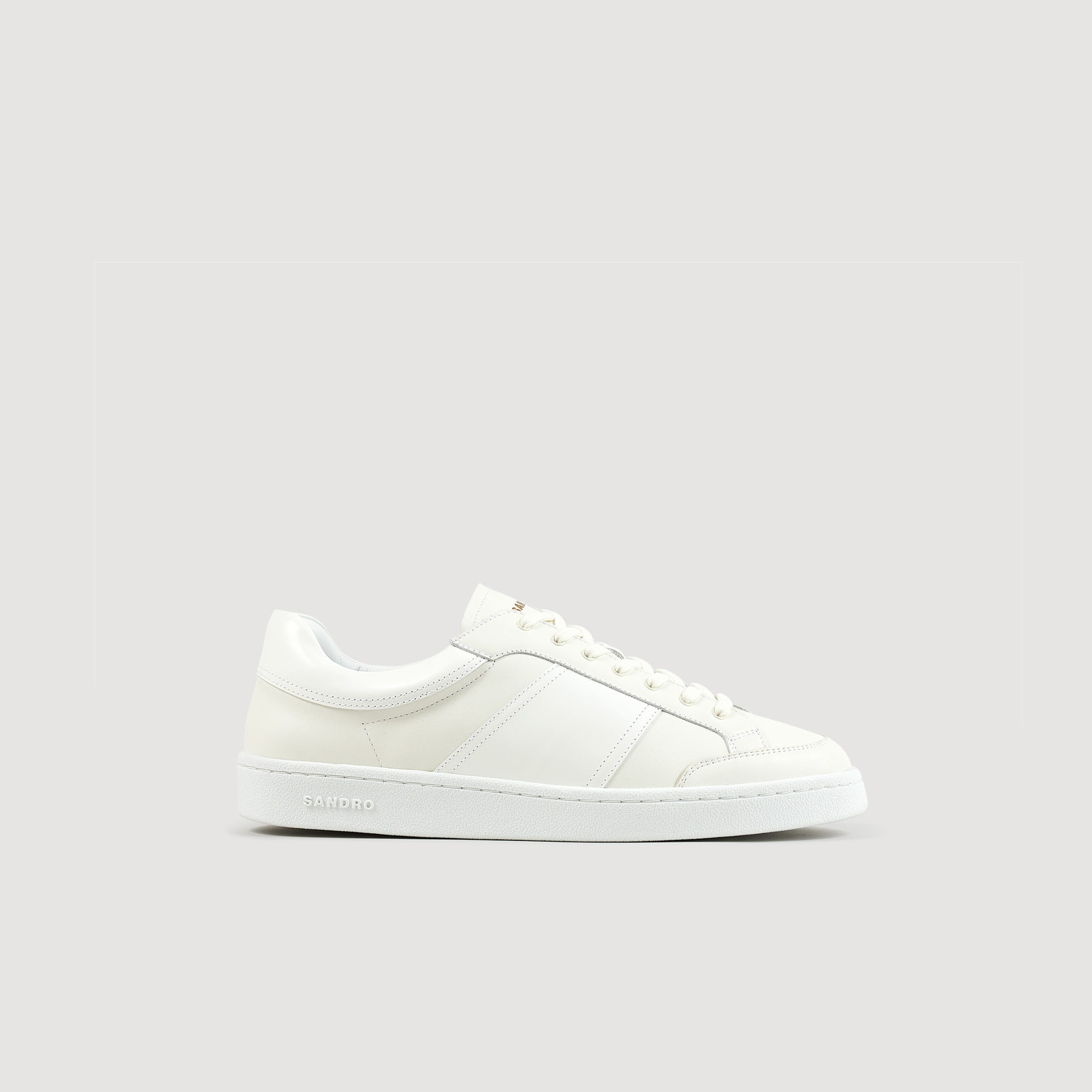 Sandro rubber Leather: cow Body lining: Leather low-top sneakers featuring a bonded tongue embellished with the gold Sandro logo, a gum sole, laces, and patent leather inserts on the sides