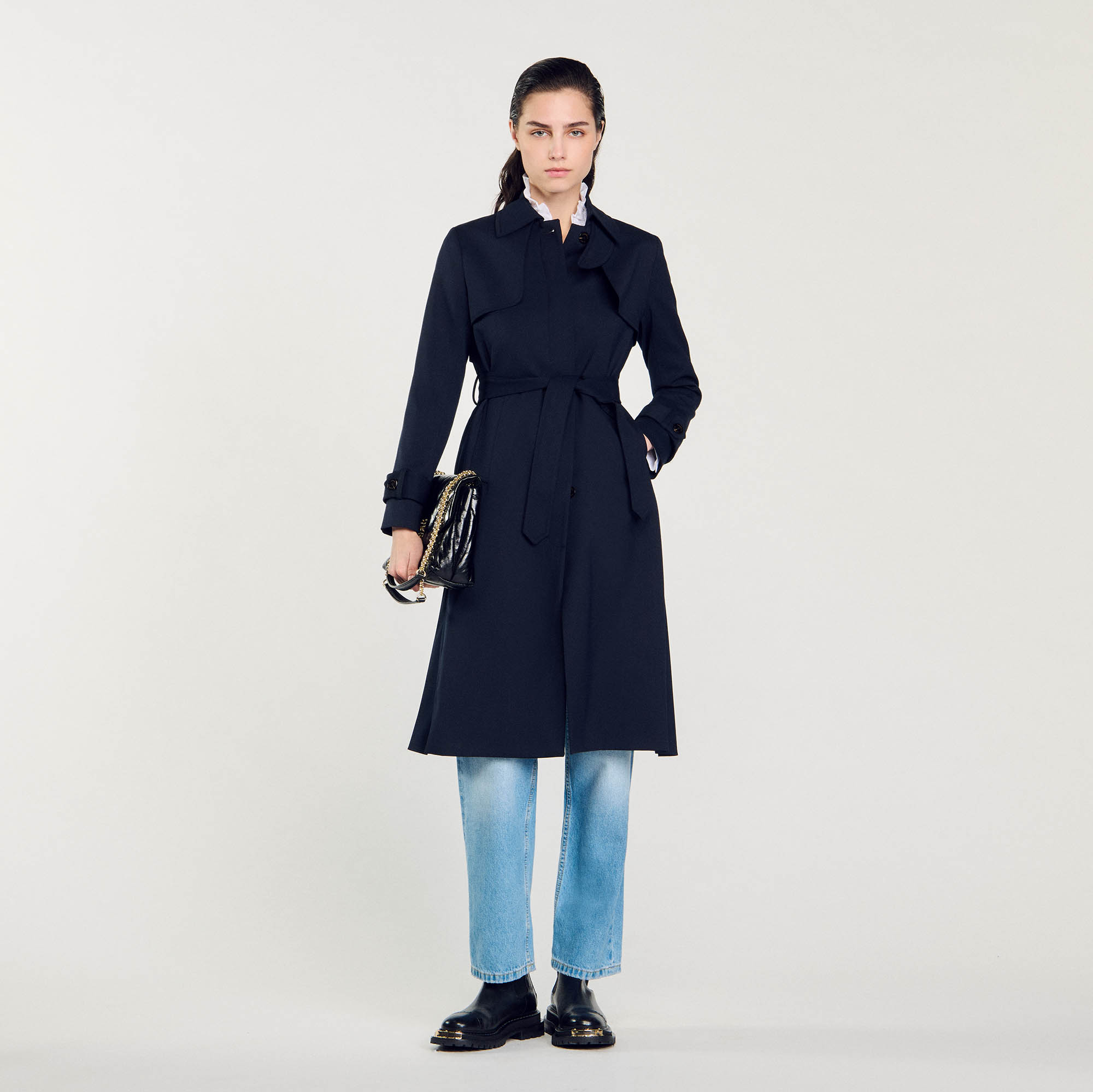Sandro polyester Sandro women's trench coat â€¢ Trench coat with pleated inset at the back â€¢ Two slanted pockets â€¢ Tie belt â€¢ Sandro branded press studs â€¢ Storm flap