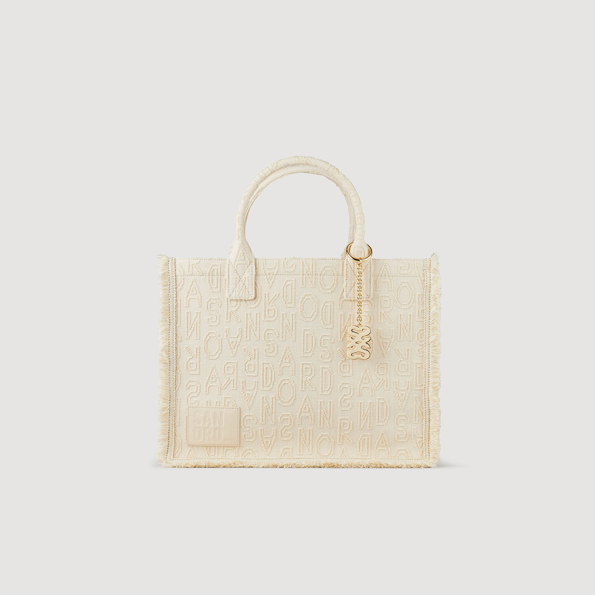 Sandro cotton Large jacquard cotton cloth tote bag embroidered with the letters Sandro and featuring handles, a magnetic fastening, a detachable jewellery chain and small fringes on the edges