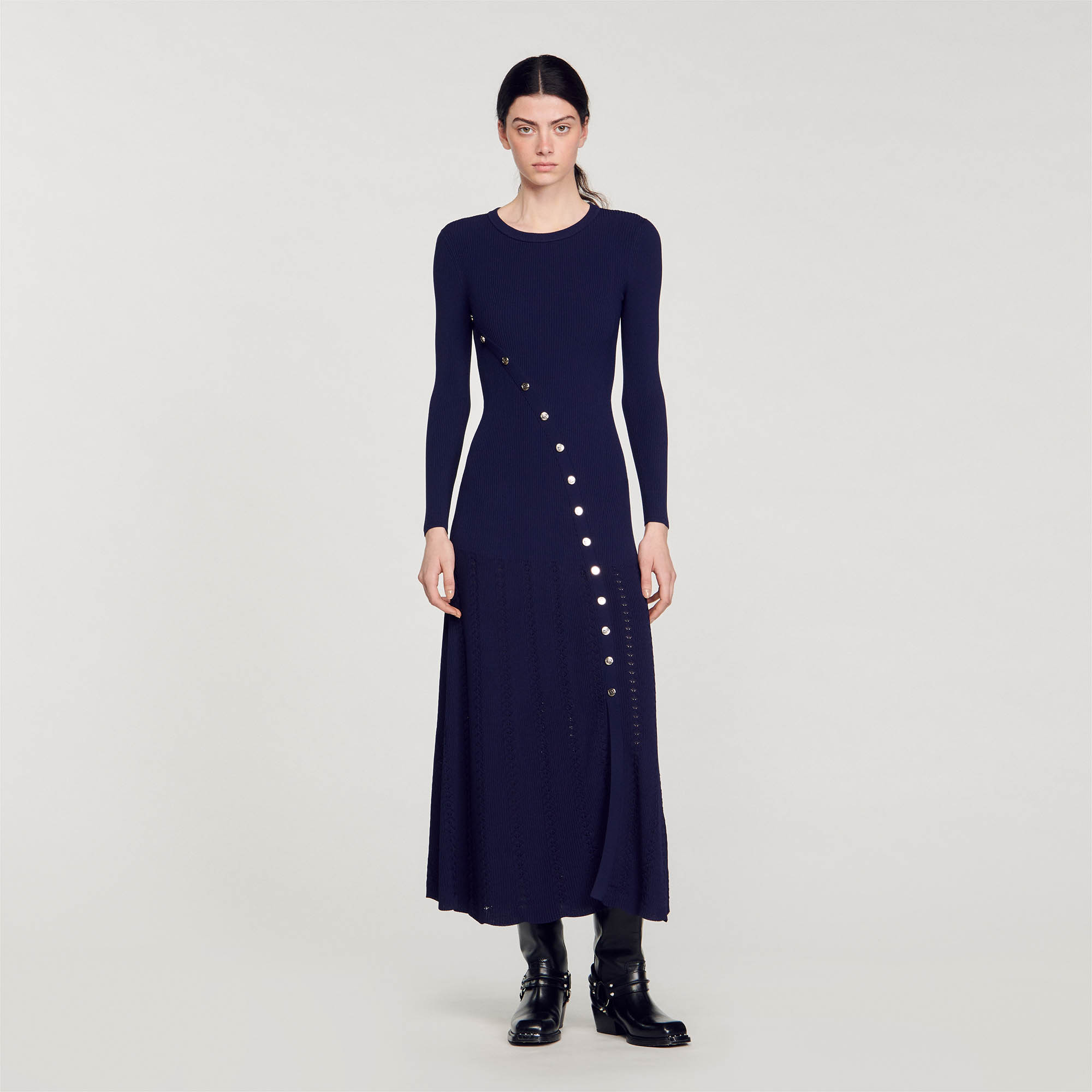Sandro viscose Rib knit round neck midi dress with long sleeves, featuring an asymmetric button fastening revealing a slit and flared fancy knit bottom