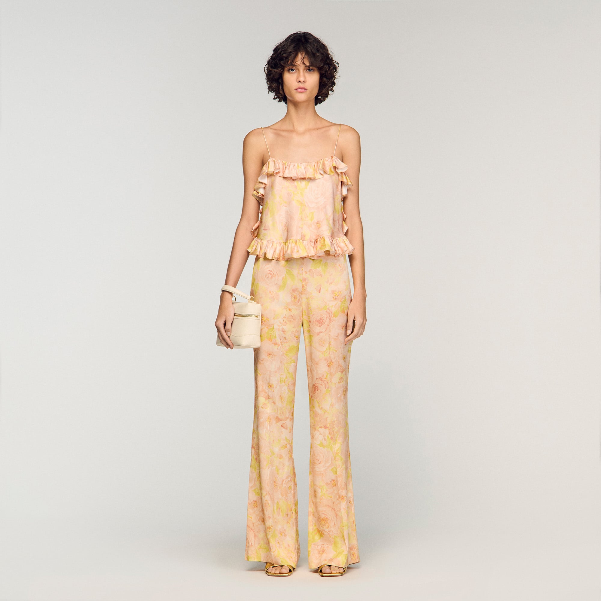 Sandro viscose Flowy trousers with a pastel floral print and slightly flared legs, featuring a high waist and ironed creases down the middle of the leg