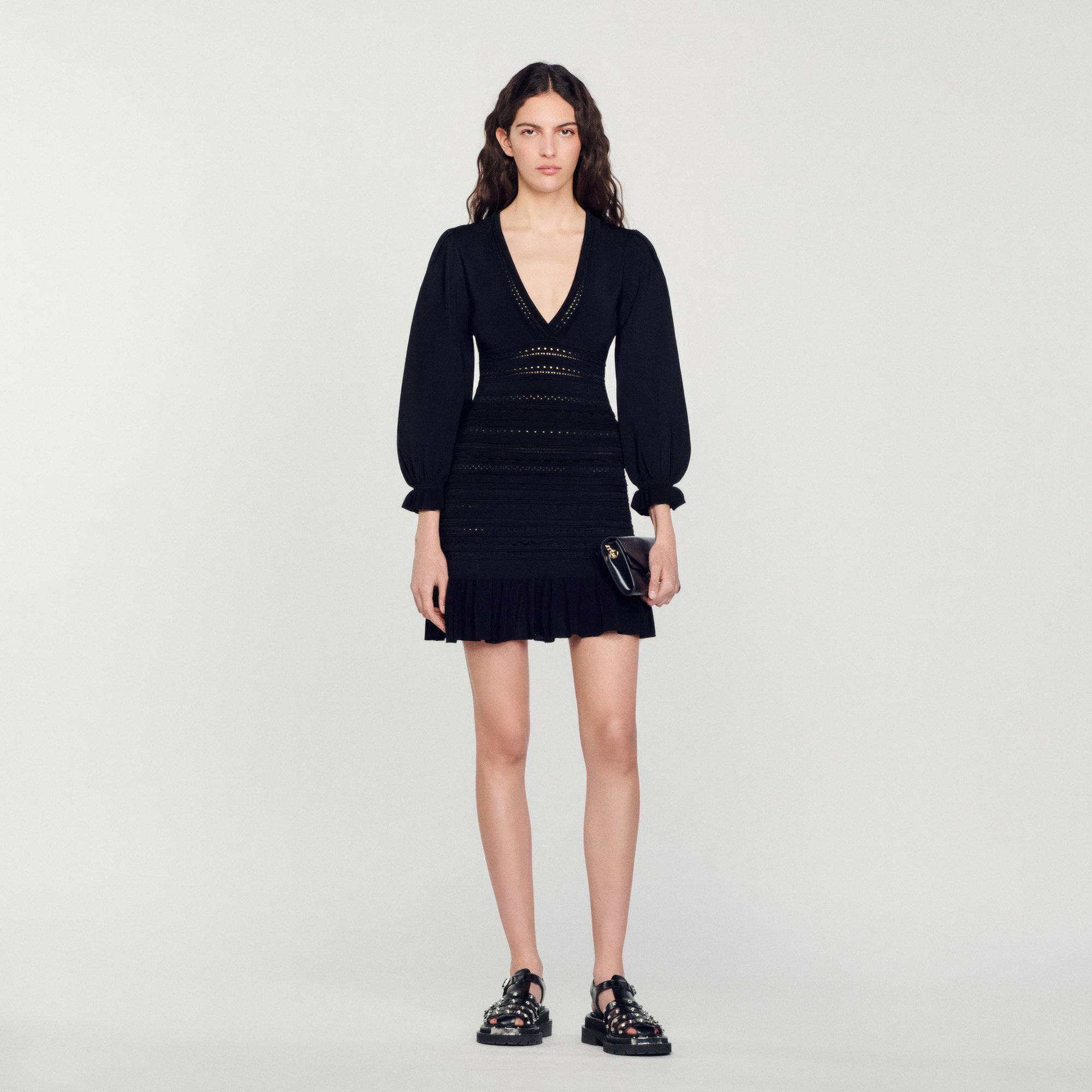 Sandro viscose Short pointelle knit dress featuring a V-shaped neckline, long sleeves, voluminous shoulders, ruffled cuffs, and a ruffle skirt with scalloped details