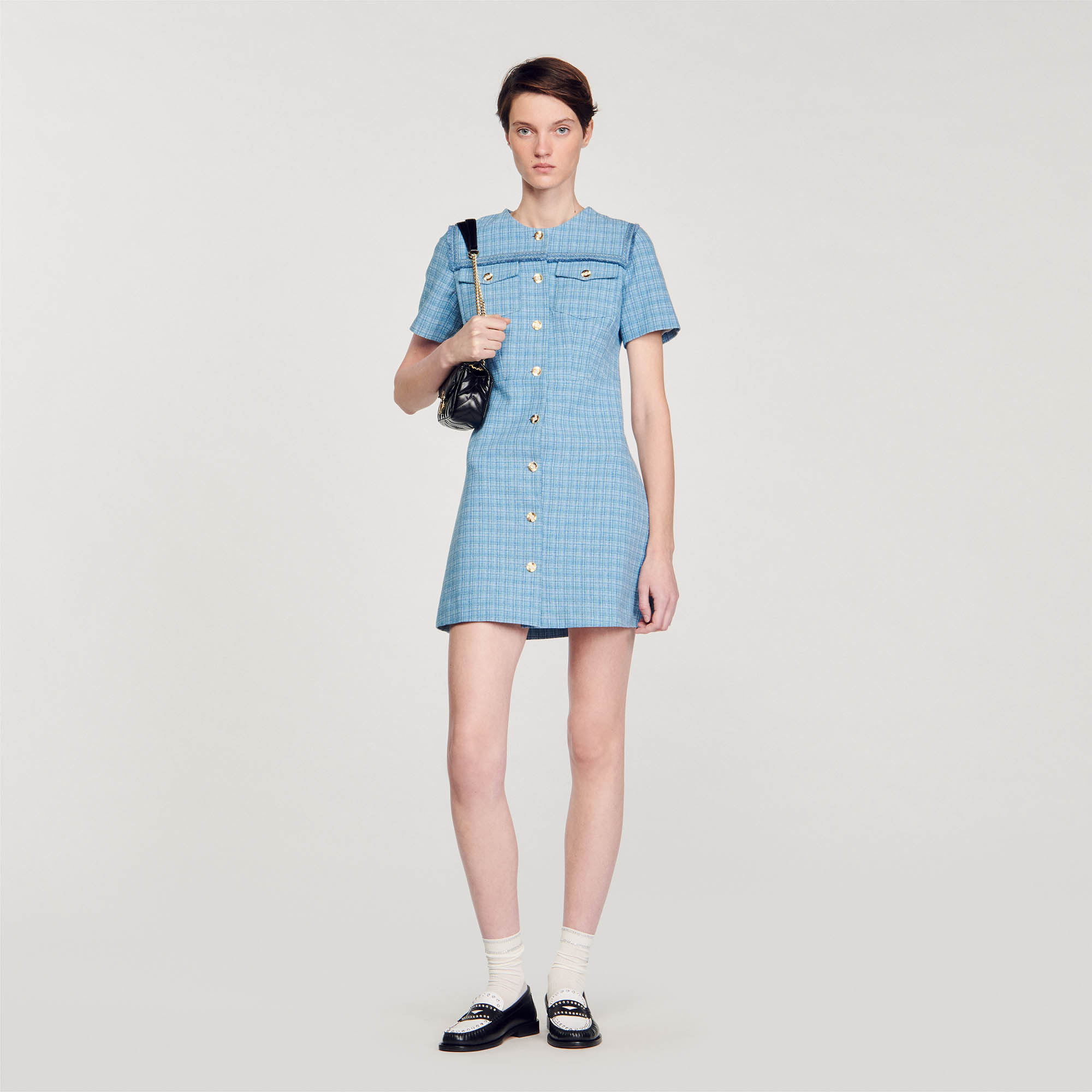 Sandro cotton Short tweed dress, fit and flare style, featuring a round neck, button fastening, short sleeves, and a flared skirt, embellished with fringed details on the neckline and patch pockets with gold buttons
