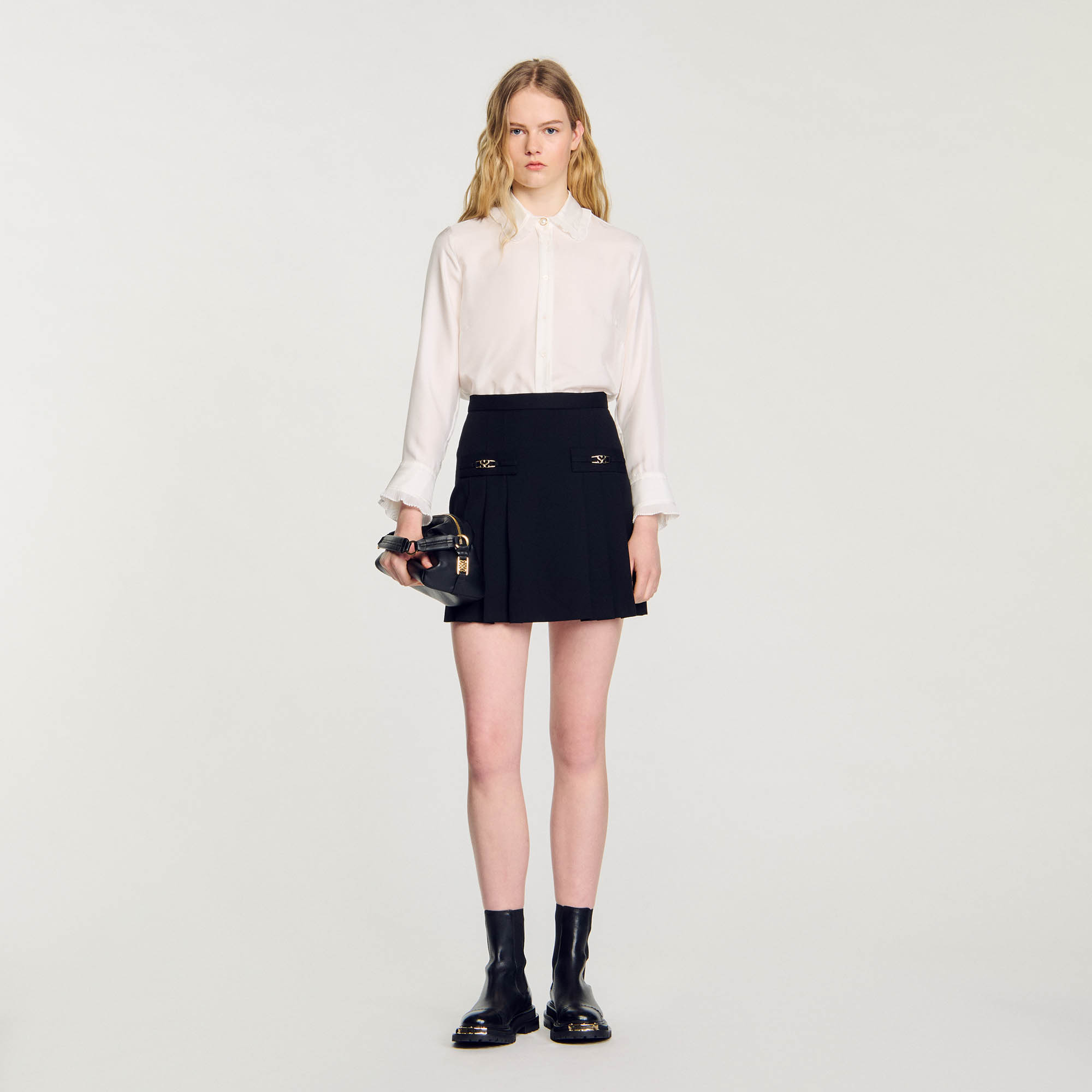 Sandro wool Sandro women's skirt â€¢ Short skirt with stitched pleats â€¢ Large trompe l'oeil piped pockets with fancy buckle created by our studio â€¢ Mid-thigh length â€¢ Fastened with a concealed zip at the center back â€¢ Model is wearing a size 36/Uk 8/Us 2-4 â€¢ Model measures 177 cm