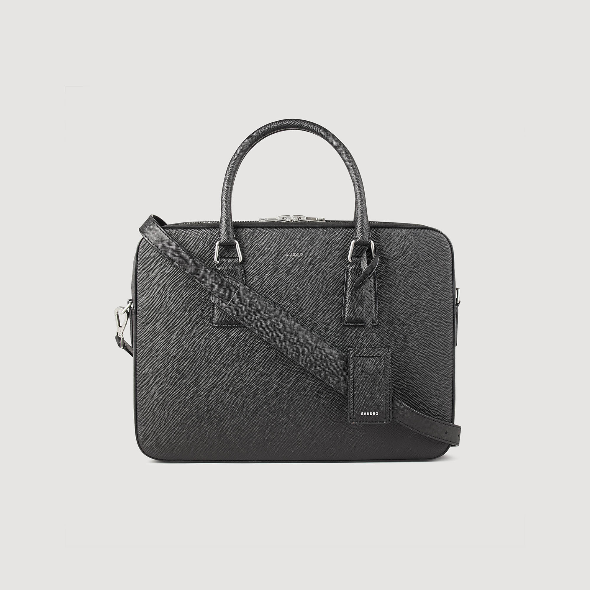 Sandro synderm Lining: Sandro men's briefcase Saffiano leather briefcase Large central compartment Embossed Sandro logo Laptop compartment Adjustable shoulder strap Technical fabric lining Luggage tag Dimensions: 11 x 15 x 3 in This item's main material is at least 50% recycled