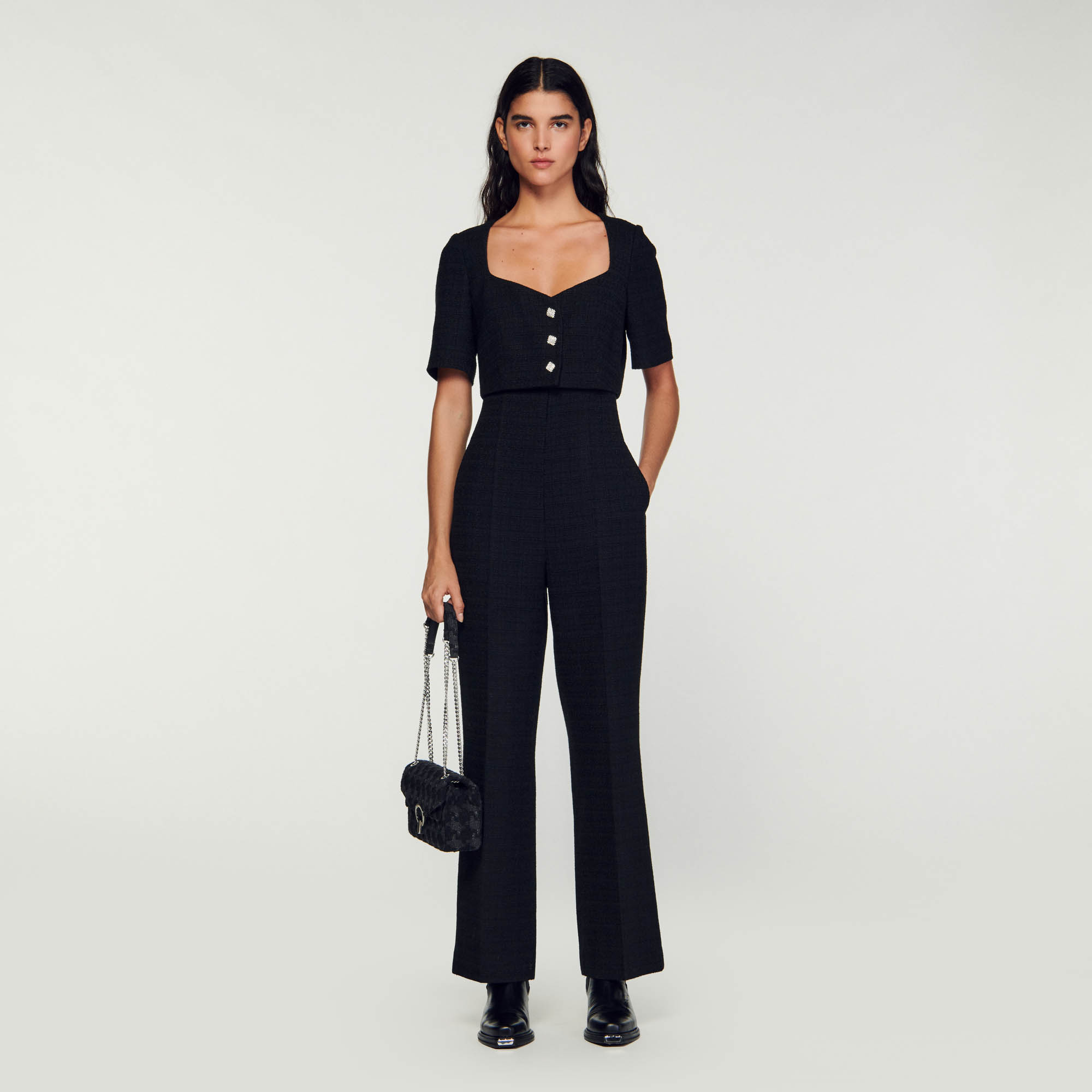 Sandro cotton 2-in-1 style tweed jumpsuit with a short top with a low-cut sweetheart neckline adorned with rhinestone jewels and pleated pants with slightly flared hems