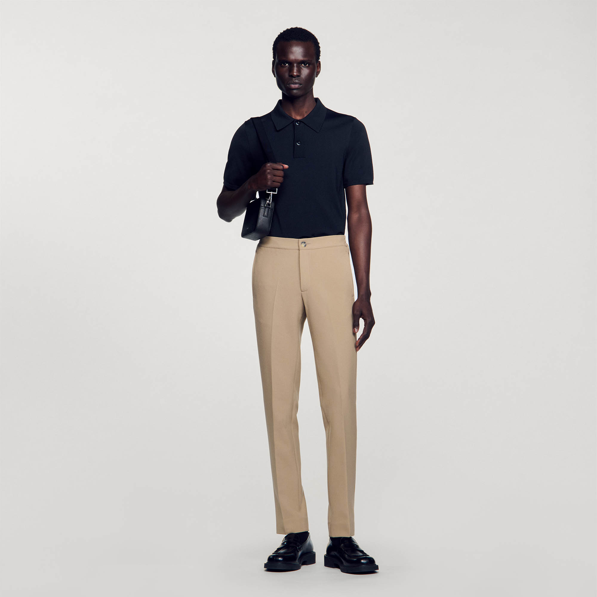 Sandro polyester Sandro men's pants â€¢ Jersey pants â€¢ Button fastening at the front â€¢ Elasticated waist at the back â€¢ Slanted pockets at the front â€¢ Two piped pockets at the back â€¢ The model is wearing a size 38