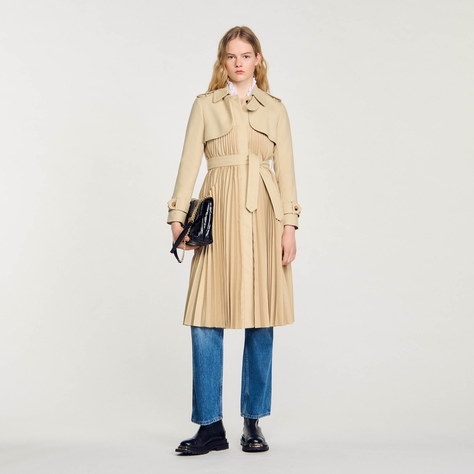 Sandro polyester Lining: Sandro women's trench coat â€¢ Pleated trench coat with belt Pockets at the front Tabs on the cuffs and shoulders â€¢ Storm flap â€¢ Eco-friendly buttons in organic resin The model is 5'10 tall and wears a size 36 FR / 4 US