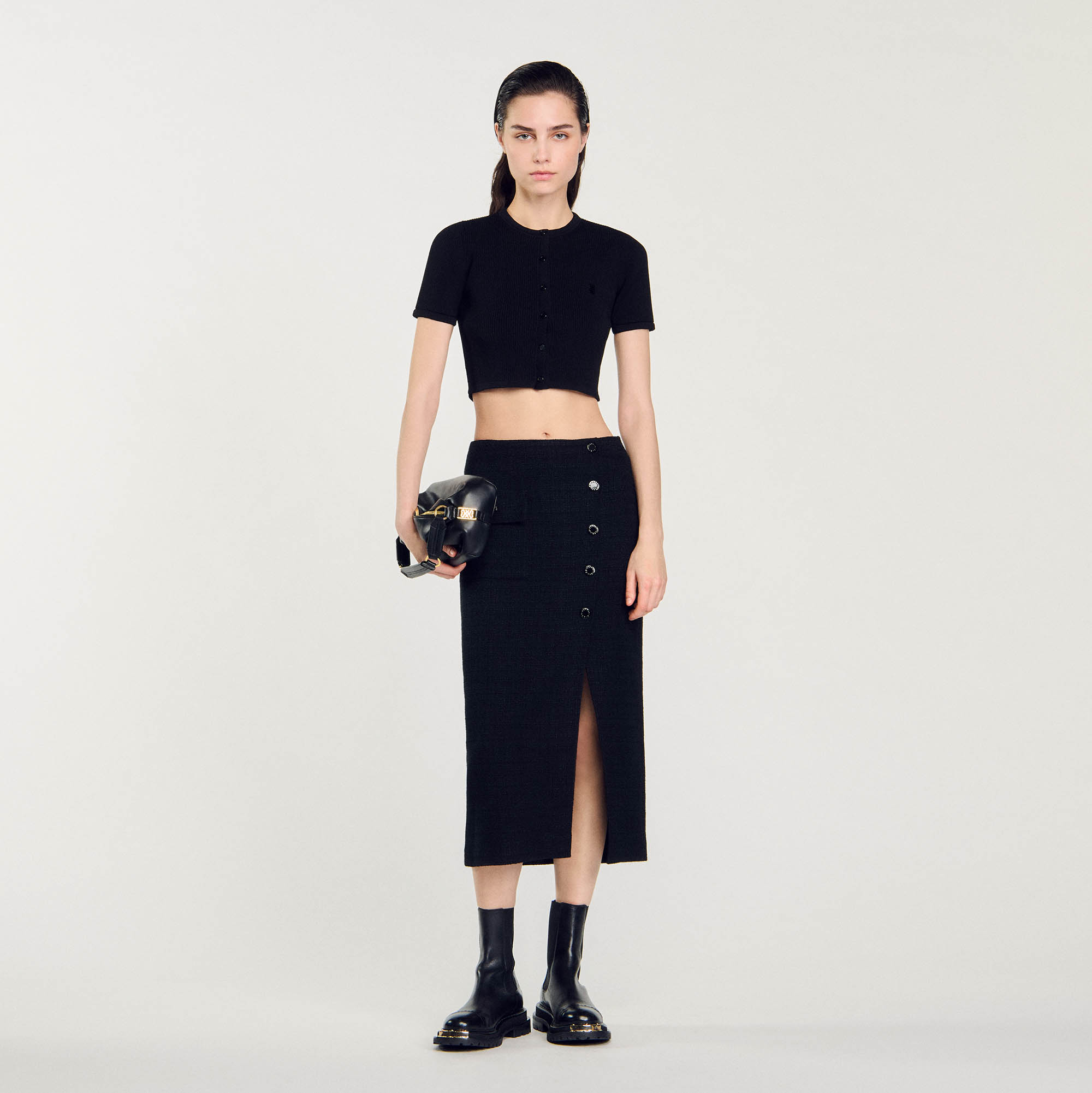 Sandro cotton Tweed midi skirt with a slit in the front, a flap patch pocket on the side, and Sandro-branded snap fasteners