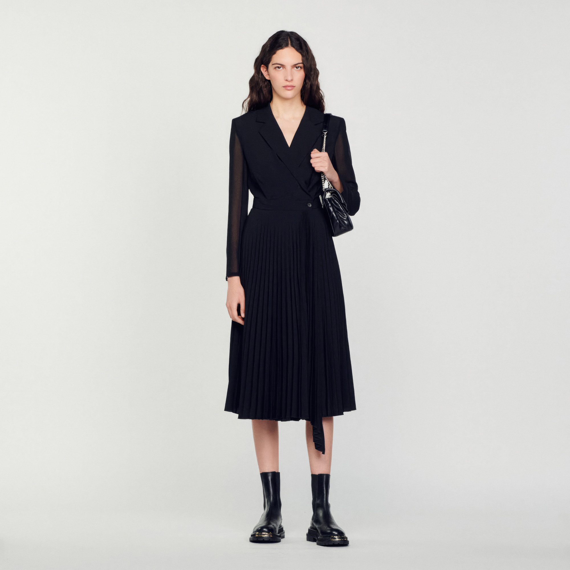 Sandro polyester Secondary fabric: Sandro women's dress â€¢ Crossover tailored collar fastened with a button â€¢ Long sheer sleeves â€¢ Pleated asymmetric skirt This item's main material is at least 50% recycled