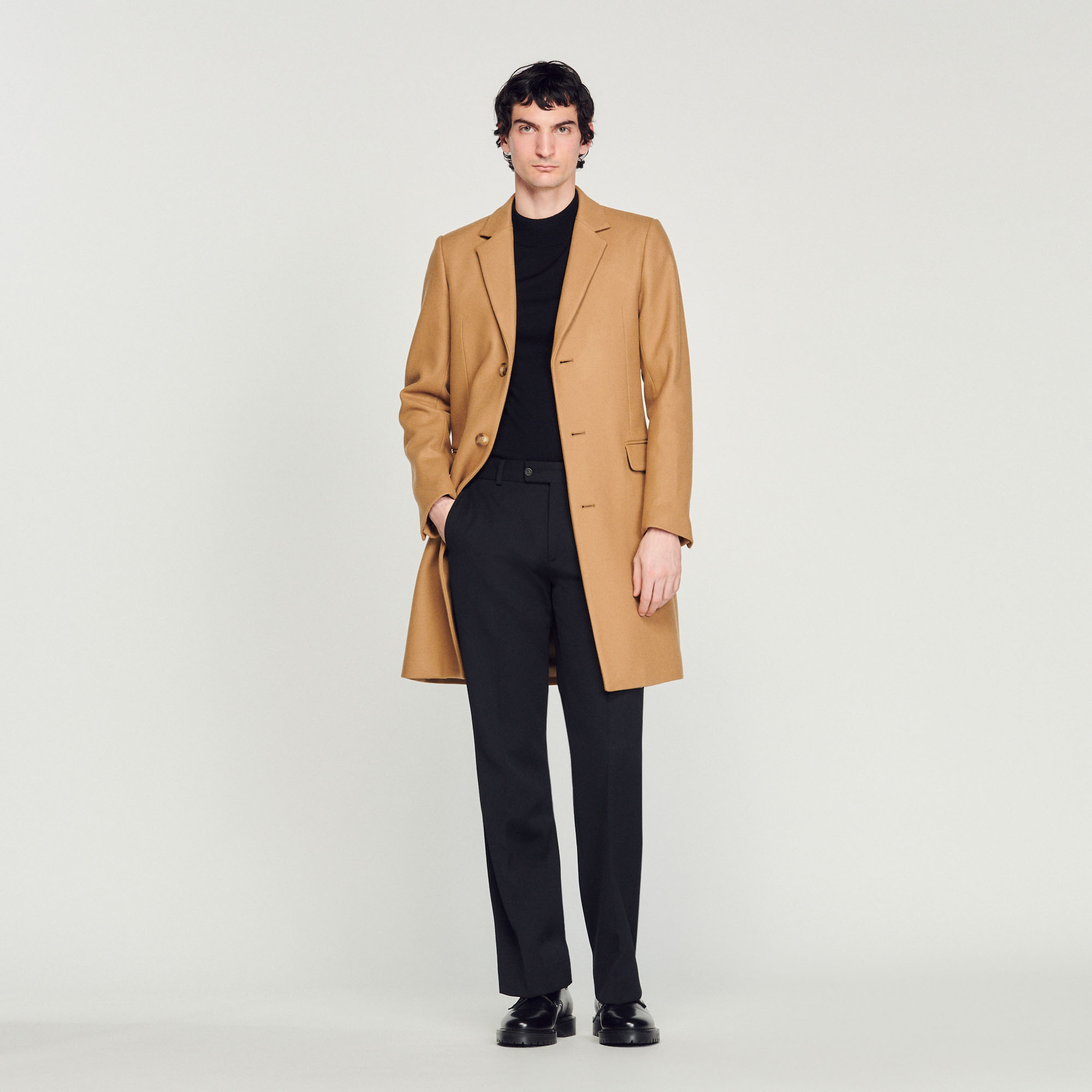 Sandro wool Sandro men's coat â€¢ Wool coat â€¢ Tailored collar â€¢ Fastened with three buttons â€¢ Side pockets with flap â€¢ Internal pockets â€¢ Vent at the back â€¢ Fitted cut Model is wearing a size S and is 6'1''