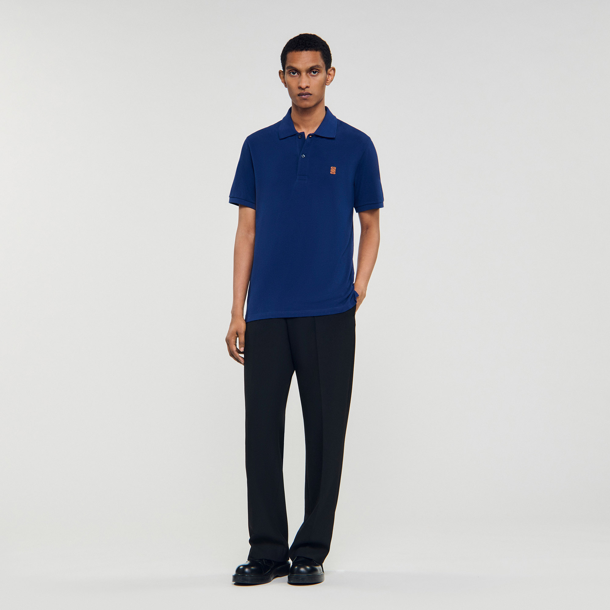 Polo shirt with leather logo