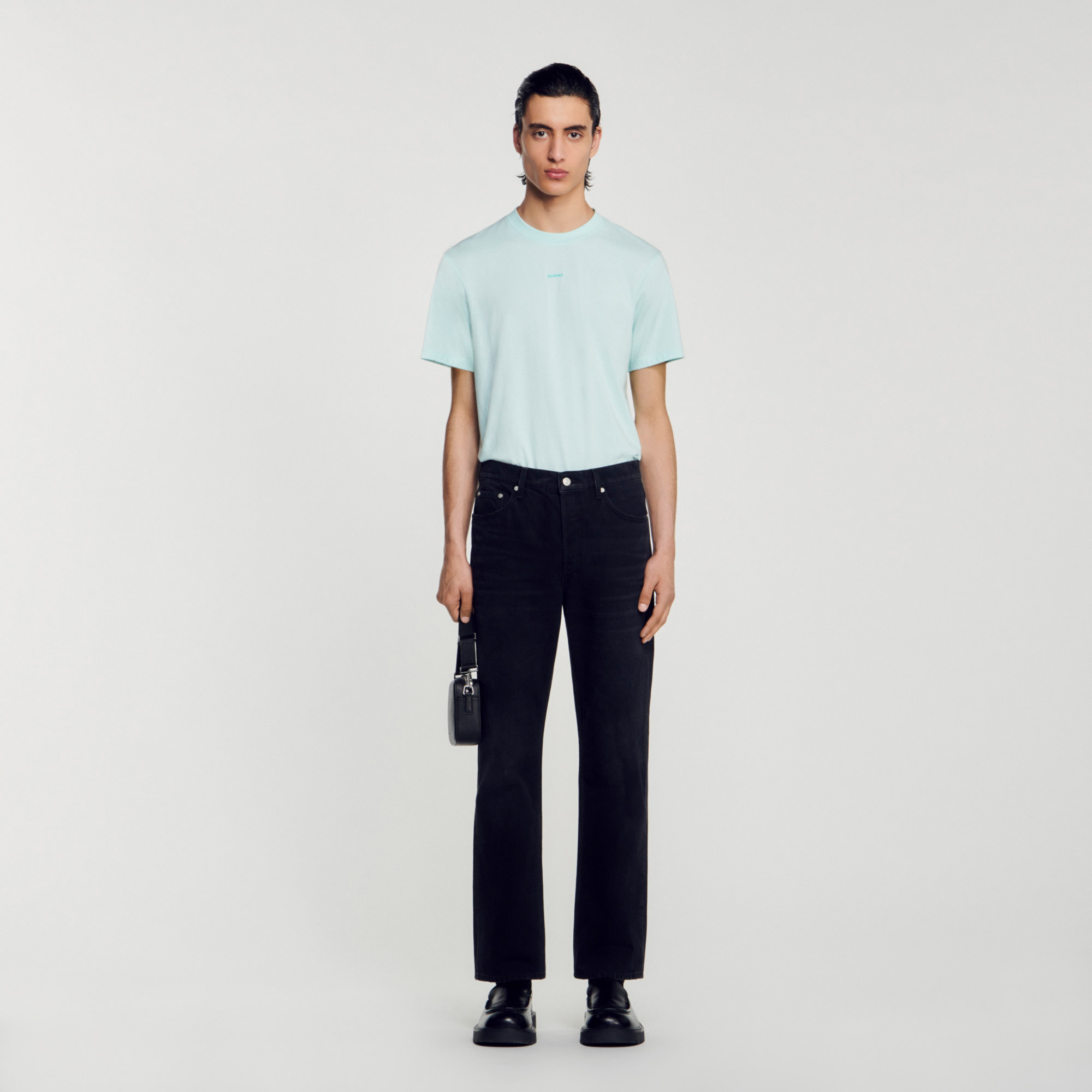 Sandro cotton Straight-leg denim jeans with five pockets and a leather jacron on the back